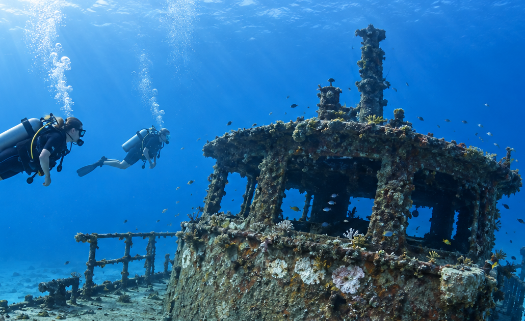 Portillo wreck dive Scuba divers exploring the coral-covered Portillo wreck near Las Terrenas